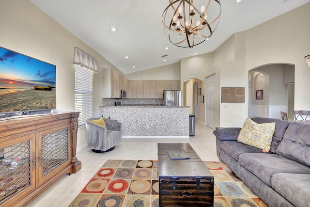 living room featuring arched walkways, light tile patterned flooring, a notable chandelier, and recessed lighting