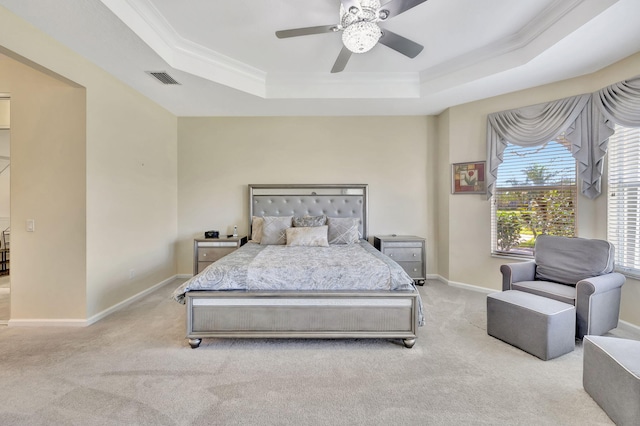 bedroom featuring baseboards, visible vents, a tray ceiling, and carpet flooring