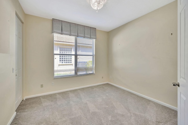 empty room with carpet floors and baseboards