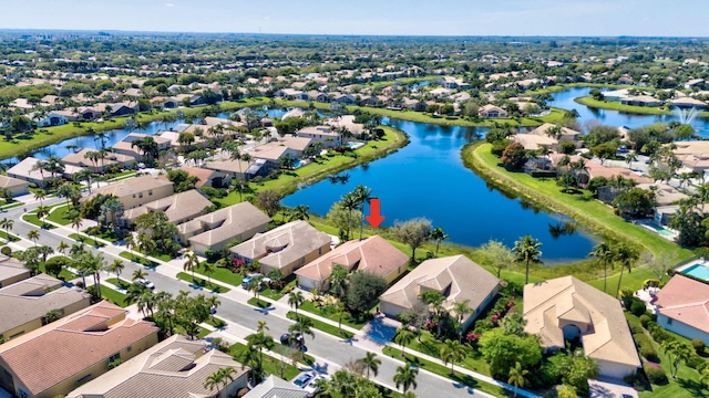 drone / aerial view with a residential view and a water view