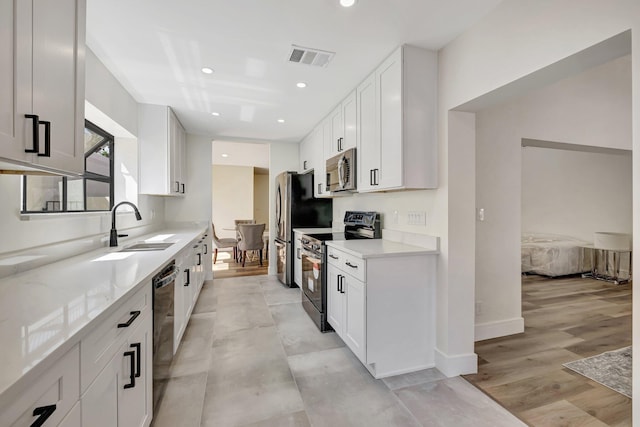 kitchen featuring recessed lighting, visible vents, appliances with stainless steel finishes, and white cabinets