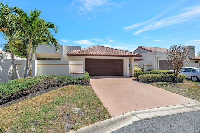 view of front facade featuring fence, driveway, stucco siding, a garage, and a tile roof