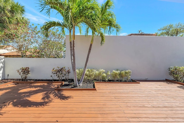 wooden terrace featuring fence