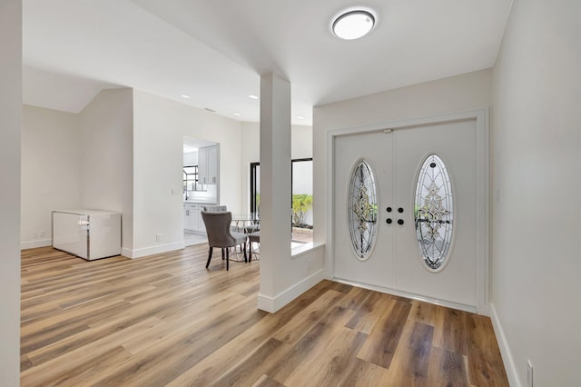 entryway featuring baseboards and wood finished floors