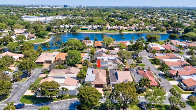 drone / aerial view featuring a residential view and a water view