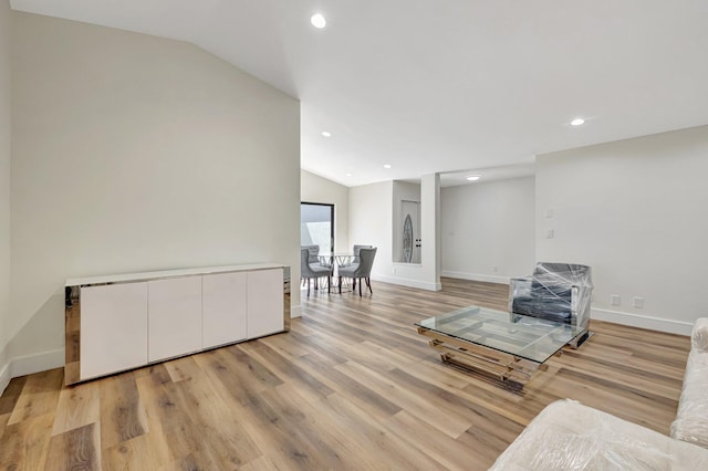 sitting room with vaulted ceiling, light wood-style flooring, recessed lighting, and baseboards