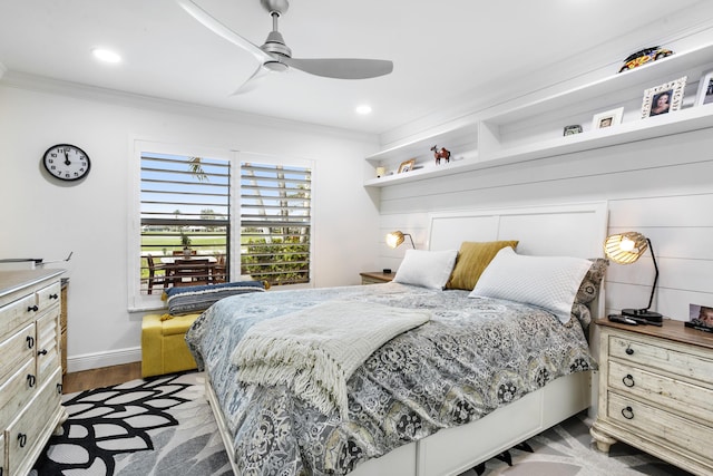 bedroom featuring ceiling fan, recessed lighting, wood finished floors, baseboards, and crown molding