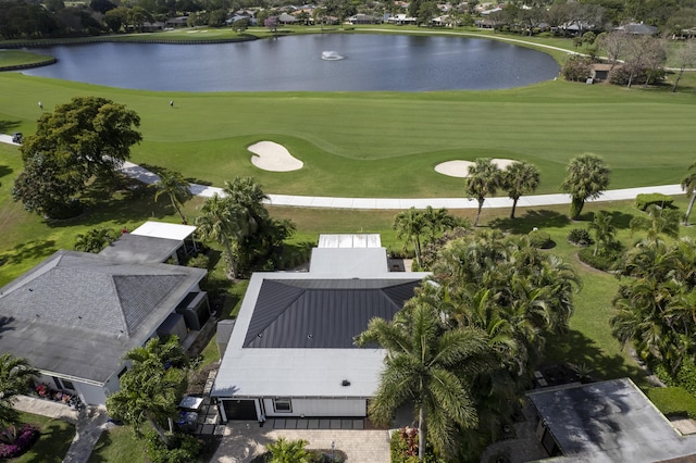 birds eye view of property featuring view of golf course and a water view