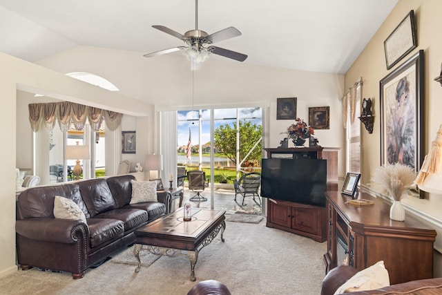 carpeted living room featuring vaulted ceiling and a ceiling fan