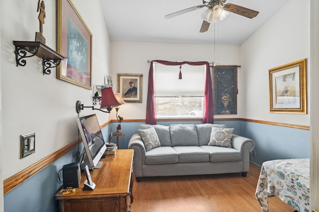 living area featuring ceiling fan and wood finished floors