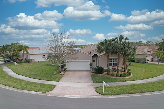 view of front of home featuring decorative driveway, an attached garage, a front lawn, and stucco siding