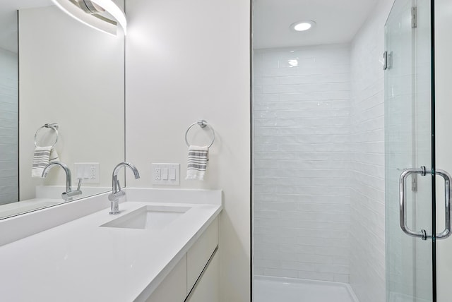 bathroom featuring vanity, recessed lighting, and a shower stall
