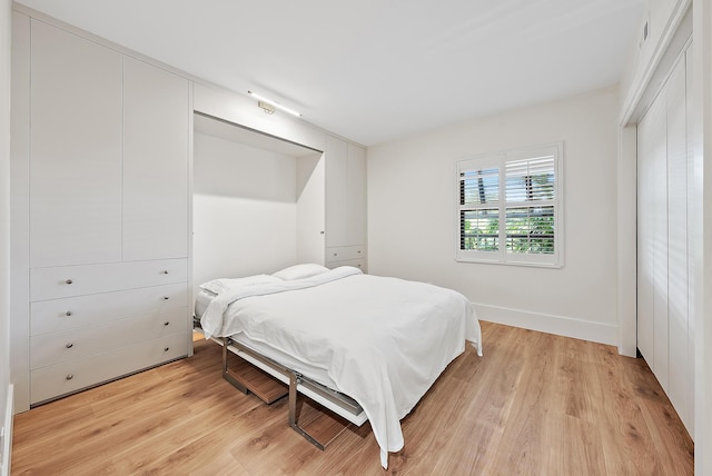 bedroom with visible vents and light wood-style flooring