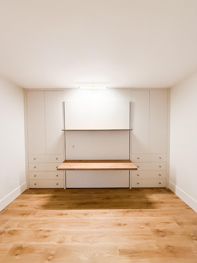basement with light wood-style floors and baseboards