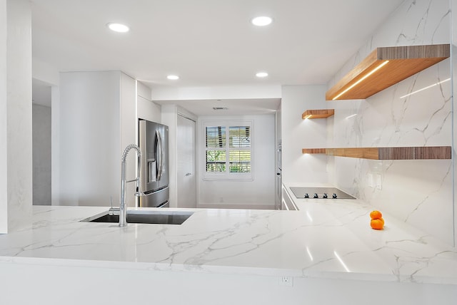 kitchen featuring recessed lighting, open shelves, a sink, and stainless steel fridge with ice dispenser