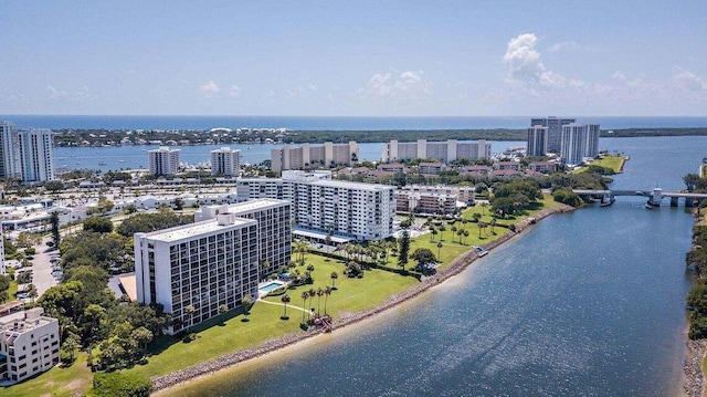 drone / aerial view featuring a view of city and a water view