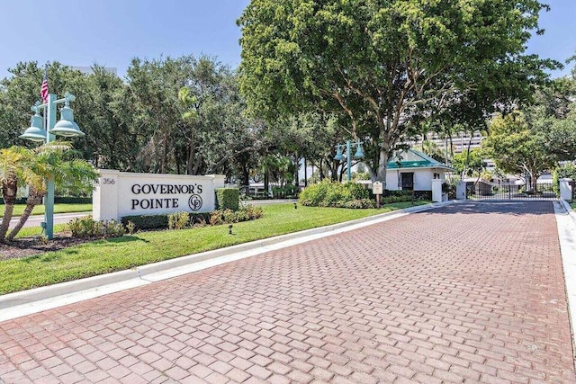exterior space featuring a lawn and decorative driveway