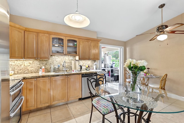 kitchen featuring tasteful backsplash, glass insert cabinets, vaulted ceiling, stainless steel appliances, and a sink