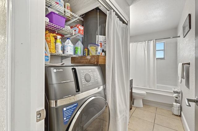 laundry area with tile patterned flooring, washer / clothes dryer, a textured ceiling, and laundry area