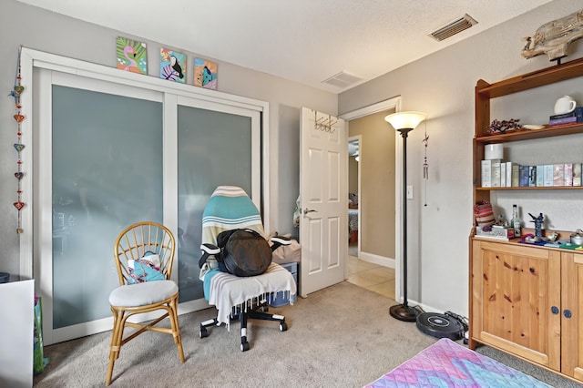 carpeted bedroom with baseboards and visible vents