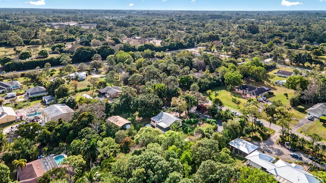 aerial view featuring a residential view and a wooded view