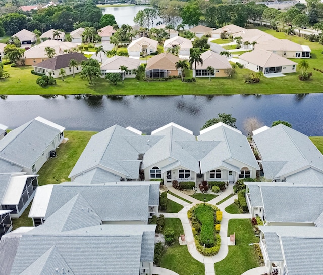 birds eye view of property featuring a water view and a residential view