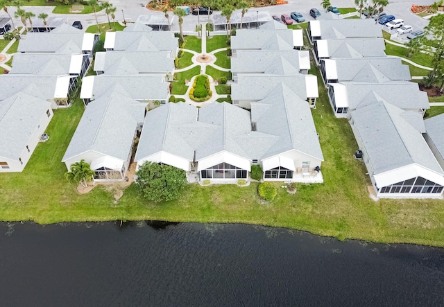 drone / aerial view featuring a water view and a residential view