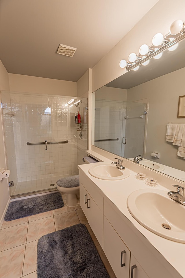 full bath with visible vents, a sink, toilet, and tile patterned floors