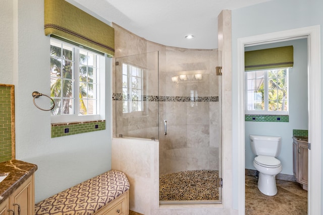 full bath with toilet, a stall shower, tile patterned floors, and vanity