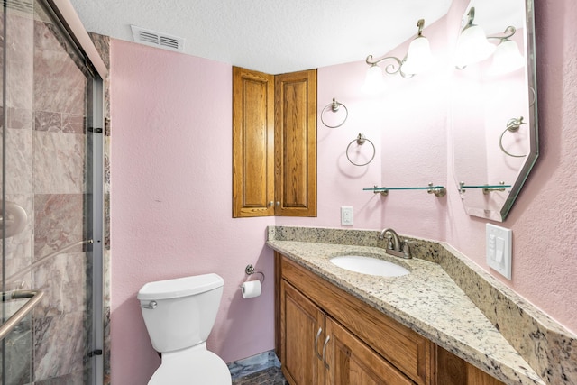 full bath with a textured ceiling, a stall shower, vanity, and visible vents