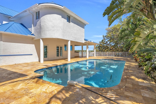 view of swimming pool featuring a fenced in pool, a patio area, and fence