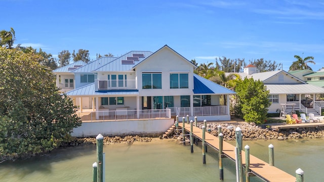 dock area featuring a water view and a balcony