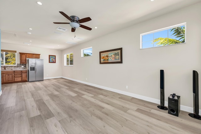 unfurnished living room with recessed lighting, visible vents, ceiling fan, light wood-type flooring, and baseboards