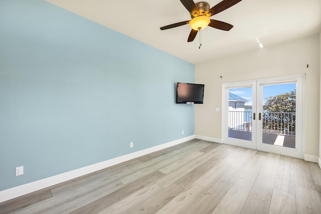 empty room featuring light wood finished floors, ceiling fan, baseboards, and french doors