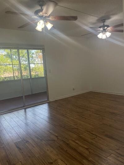 empty room with baseboards, ceiling fan, and wood finished floors