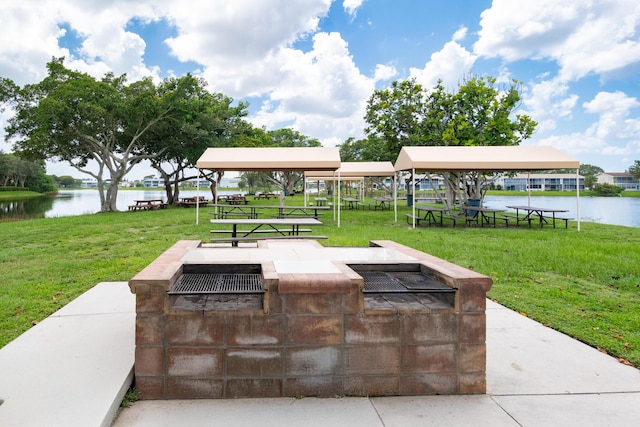 view of patio featuring a water view and a fire pit