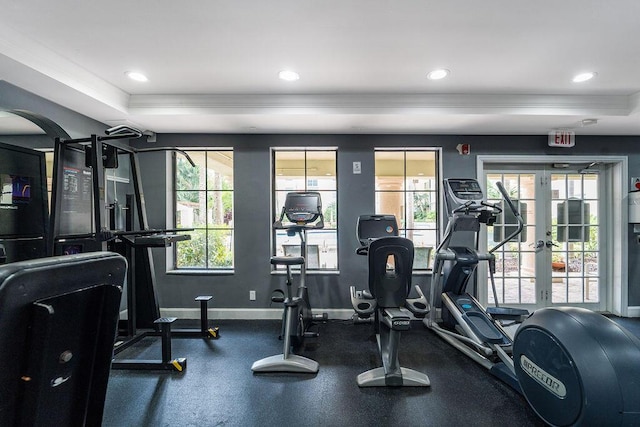 workout area featuring a wealth of natural light, a tray ceiling, baseboards, and recessed lighting