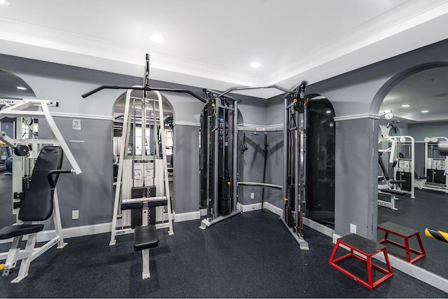 gym with baseboards, ornamental molding, a tray ceiling, and recessed lighting