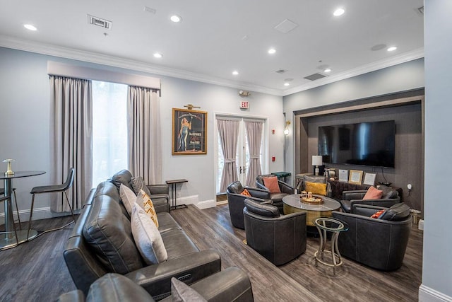 living room featuring ornamental molding, dark wood-style flooring, visible vents, and baseboards