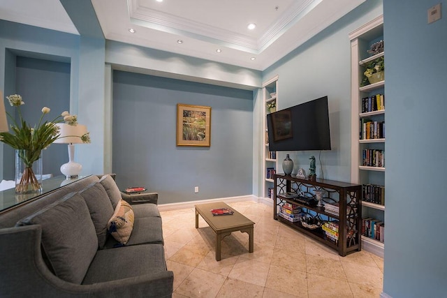 living area featuring baseboards, a raised ceiling, ornamental molding, built in shelves, and recessed lighting