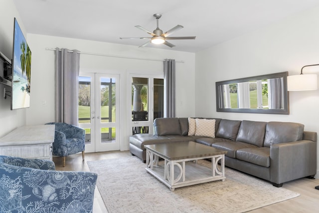 living area featuring french doors, wood finished floors, and a ceiling fan