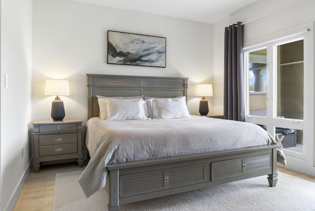 bedroom featuring baseboards and wood finished floors