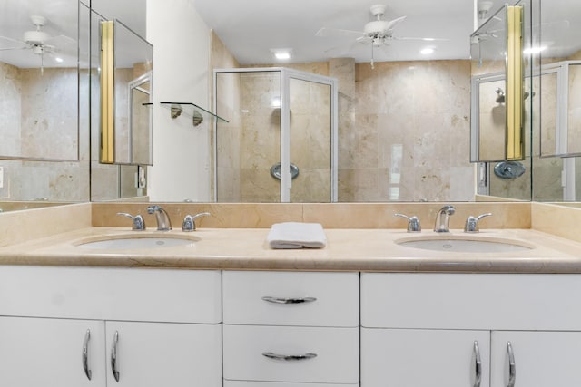 full bathroom featuring double vanity, ceiling fan, and a sink