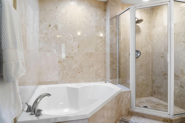 full bathroom featuring a stall shower and a garden tub