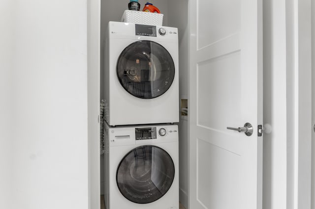 washroom with laundry area and stacked washing maching and dryer