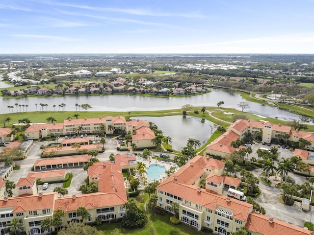 drone / aerial view with a water view and golf course view