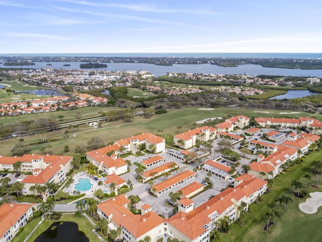 drone / aerial view featuring a residential view, a water view, and golf course view