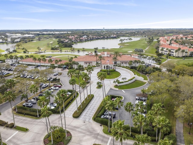 birds eye view of property with view of golf course and a water view