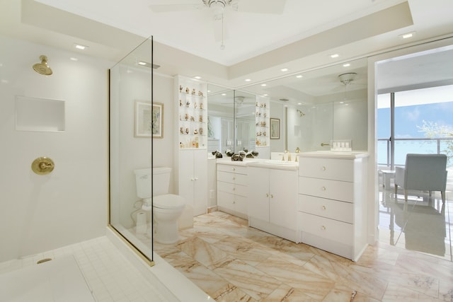 full bath featuring toilet, ceiling fan, a stall shower, and vanity