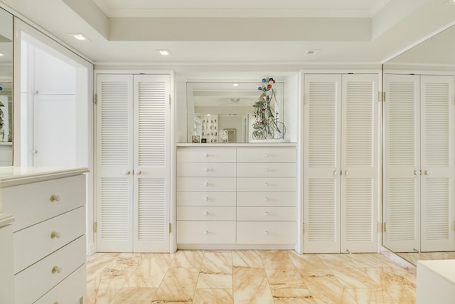 interior space featuring marble finish floor, recessed lighting, multiple closets, and crown molding